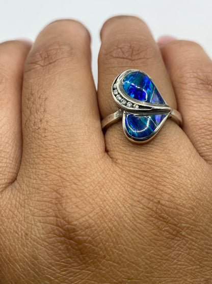 Anillo completo sobre fondo gris, sello 925 visible en la banda de plata