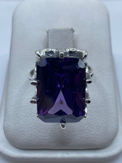 Anillo de plata solitario con circonia morada facetada en engaste envolvente