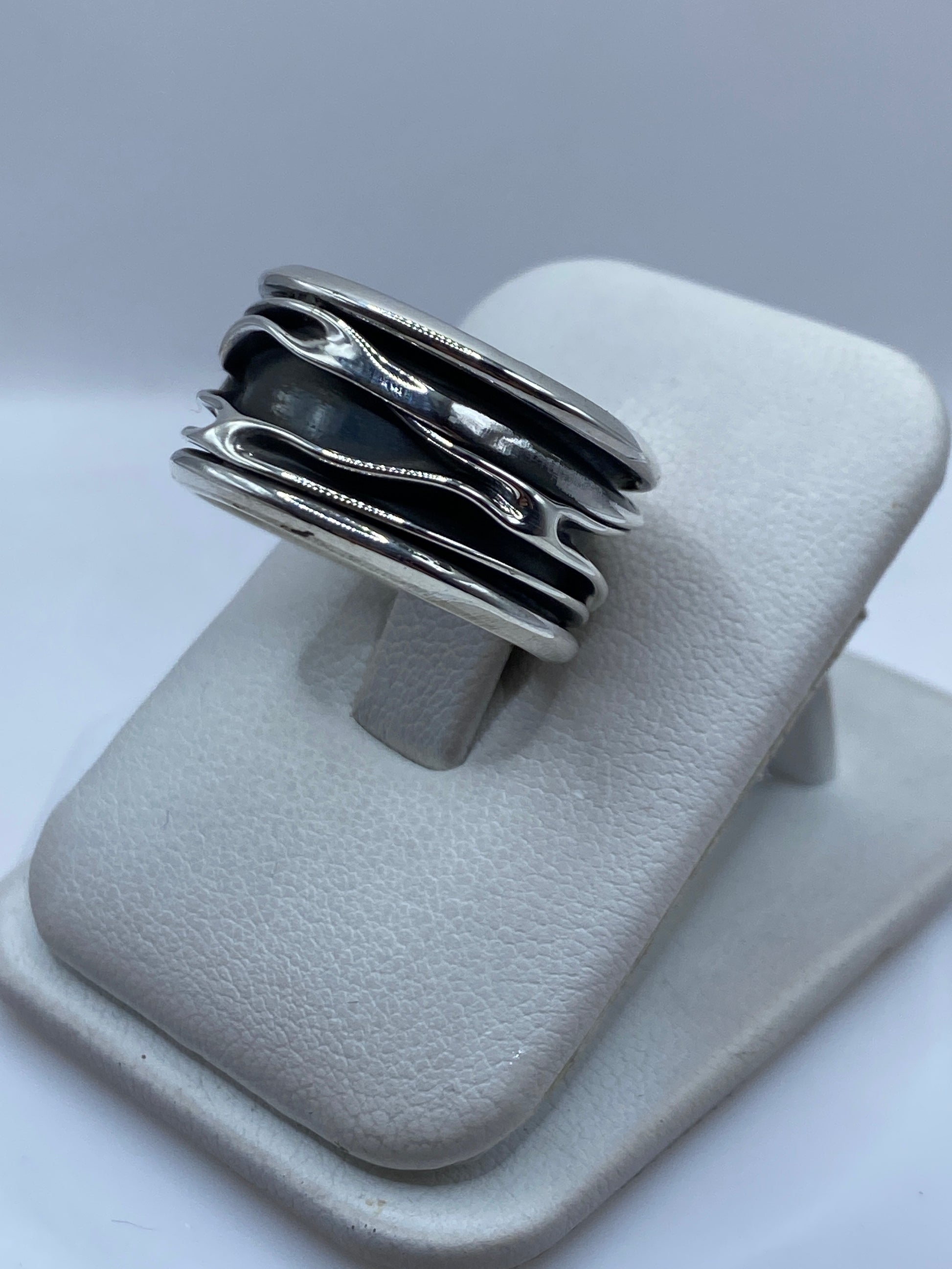 Anillo de plata bandas en la mano de un hombre, mostrando presencia y peso real