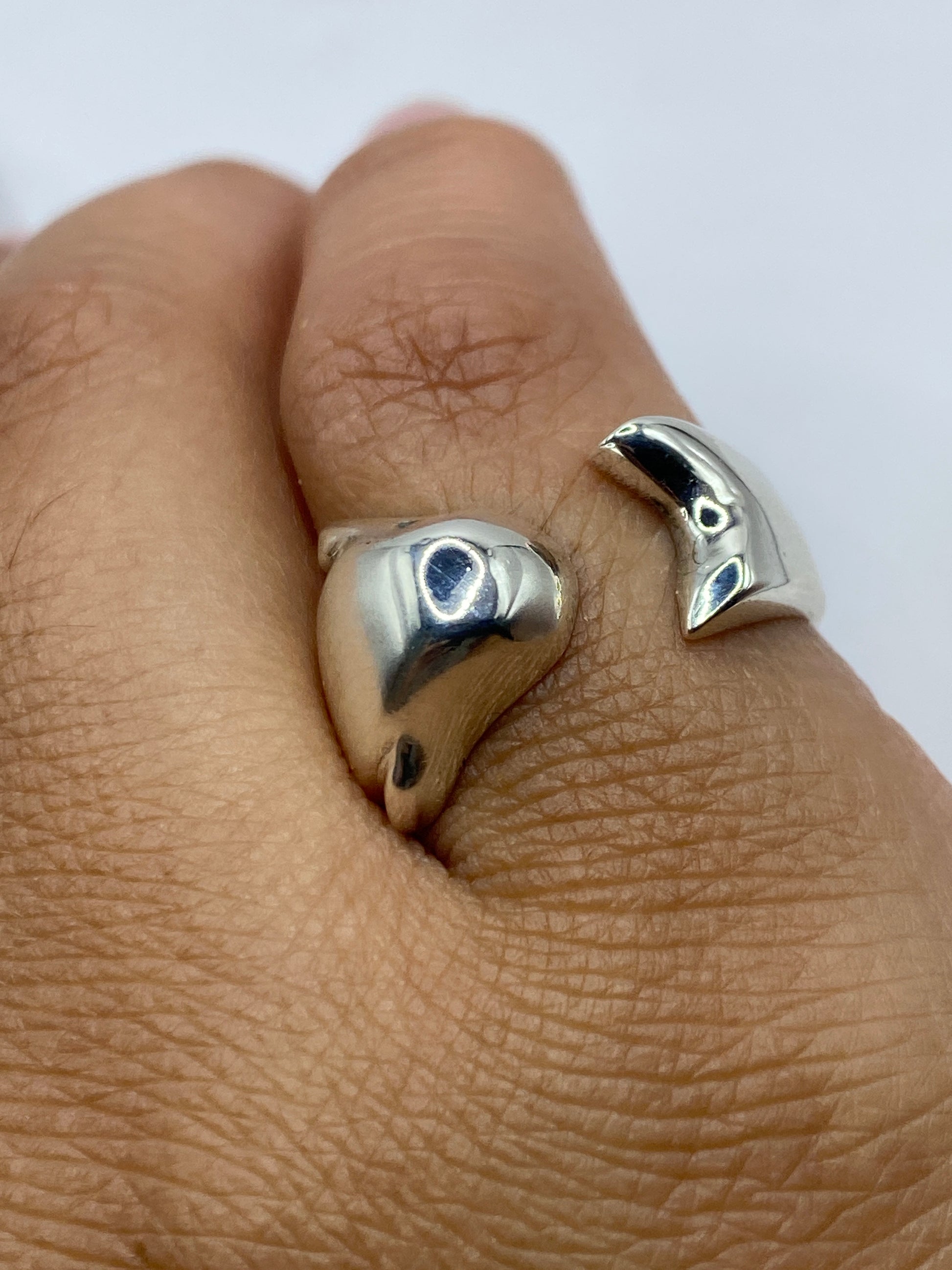 Anillo ajustable de plata en la mano, demostrando su brillo y acabado pulido