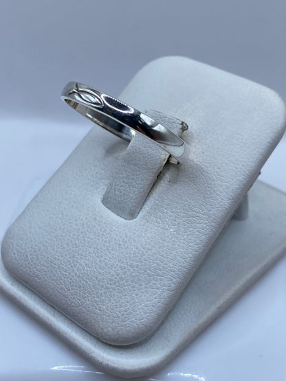 Anillo minimalista de plata en dedo de mujer, mostrando el acabado pulido