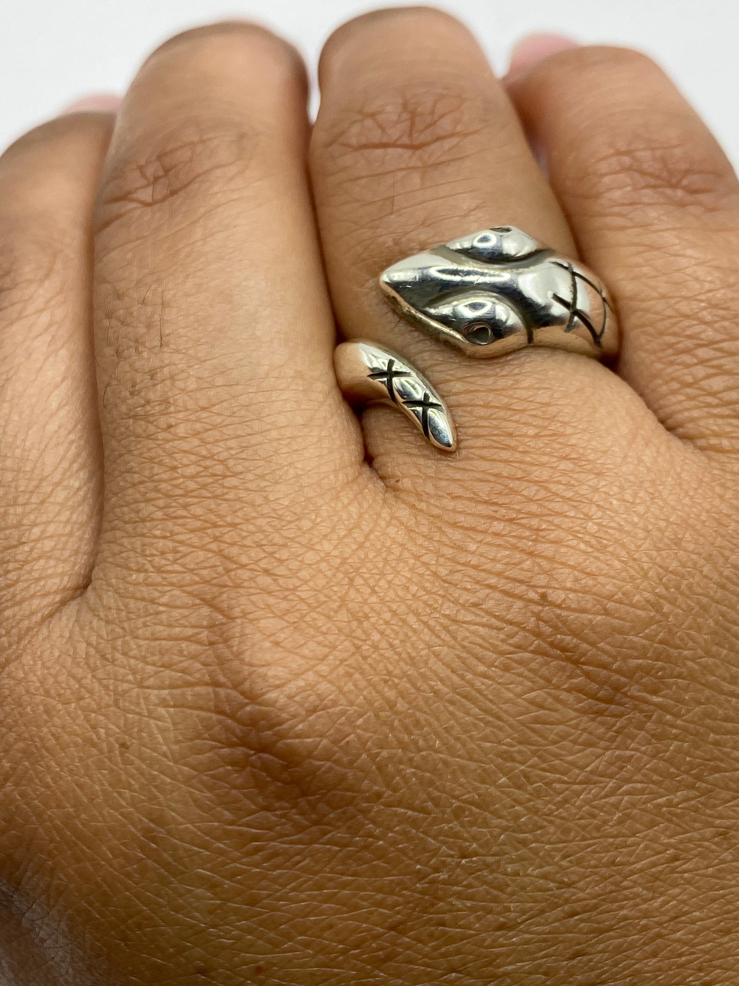 Anillo sobre fondo blanco, vista superior del diseño con ojos en plata pulida