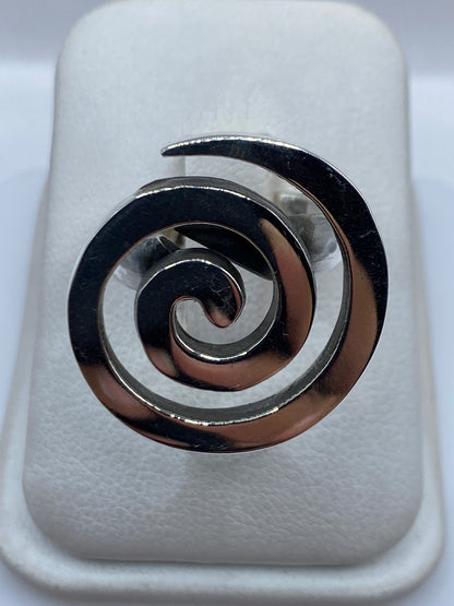 Anillo giratorio de plata con espiral doble en la mano de una mujer