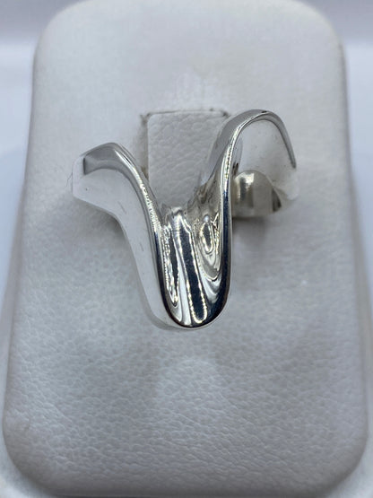 Anillo de plata cartoneado con volumen 3D sobre tela blanca