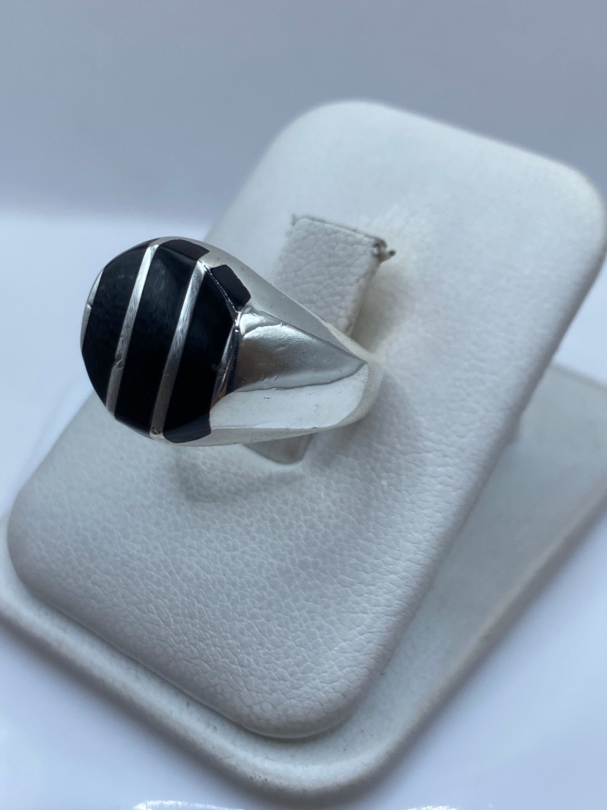 Anillo de ónix negro en mano, mostrando el tamaño y presencia de la piedra