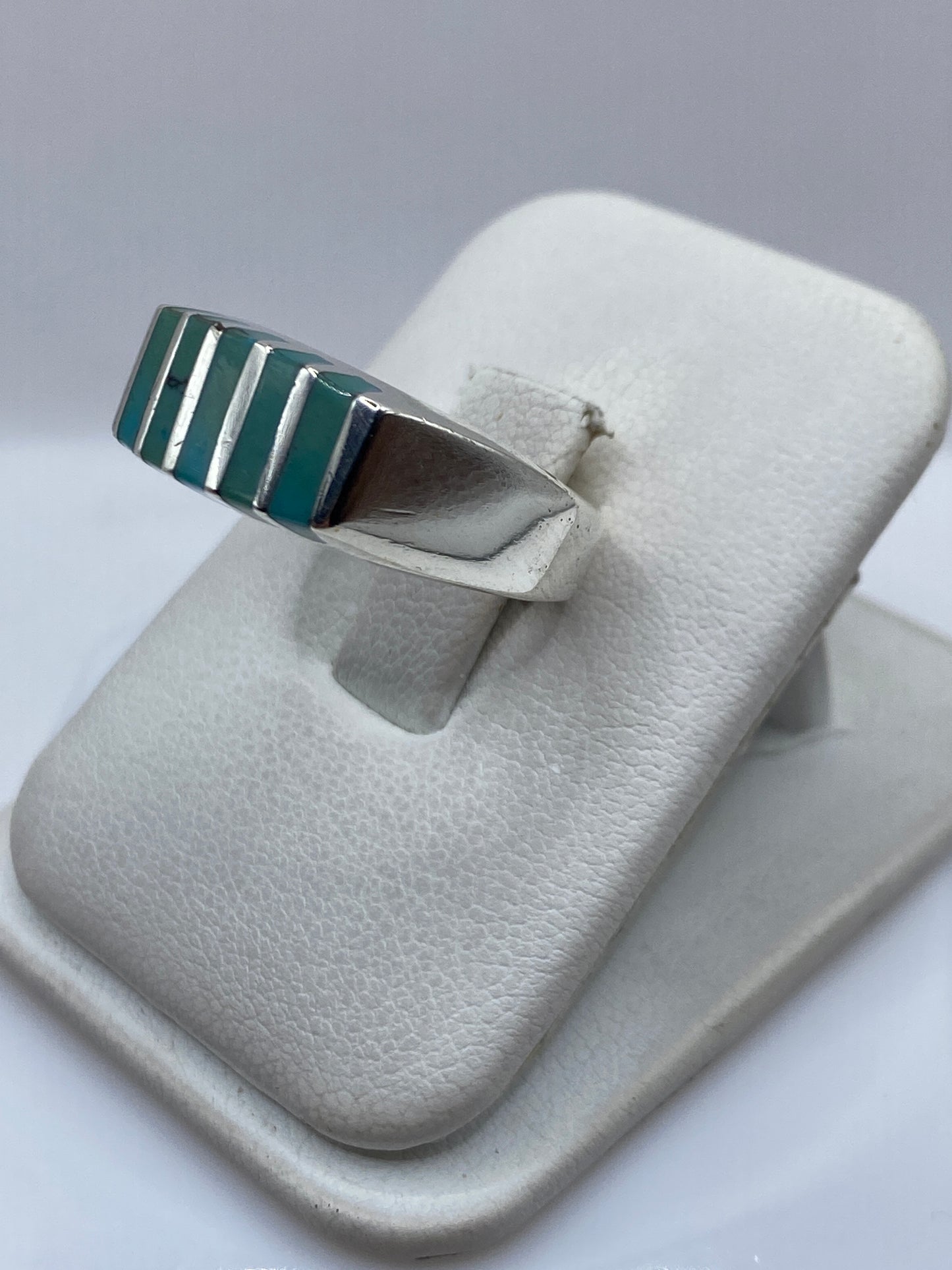 Detalle lateral del anillo mostrando el engaste a mano de la turquesa