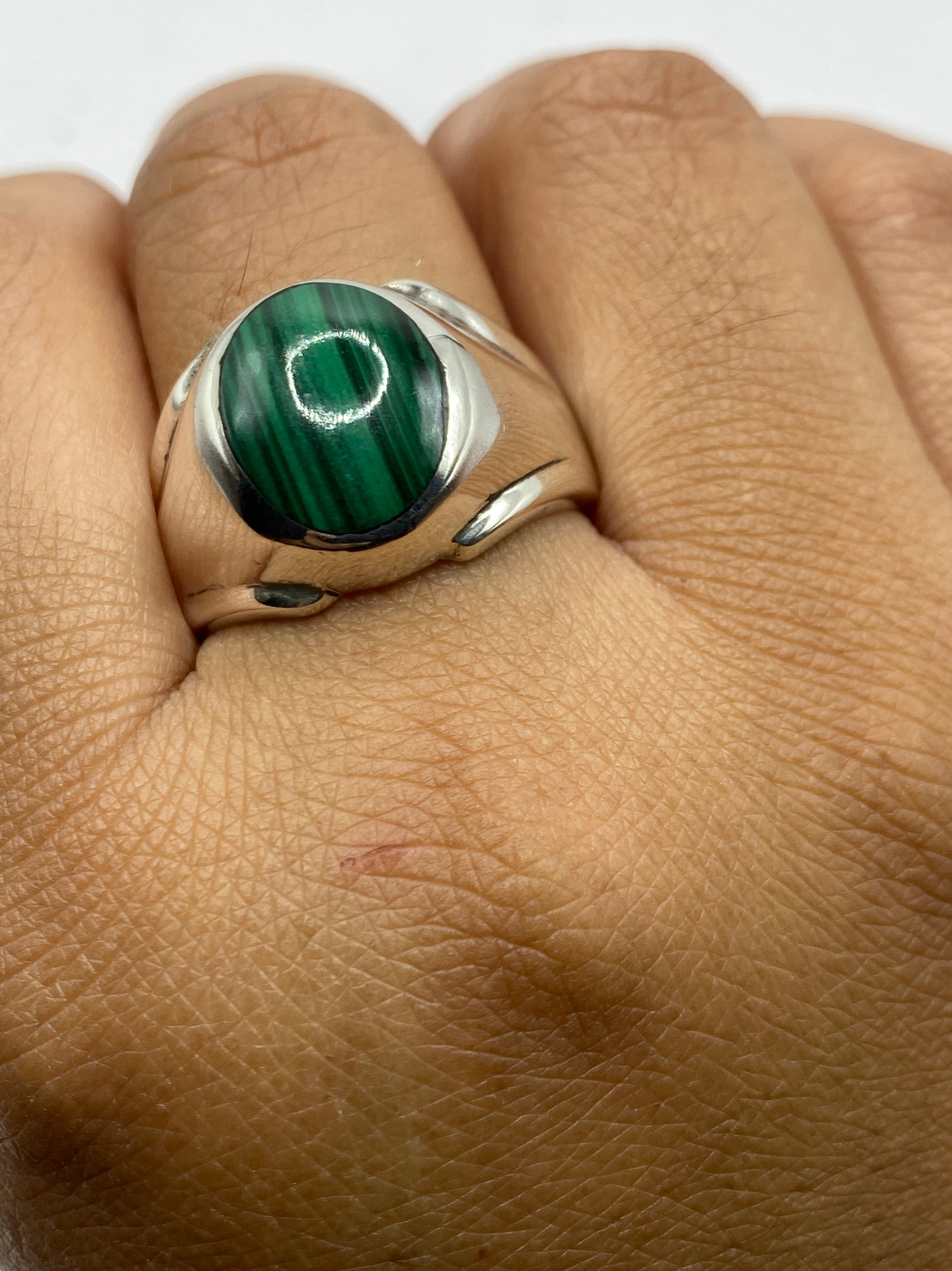 Anillo de plata .925 con marca 925 visible en el interior, sobre malaquita verde