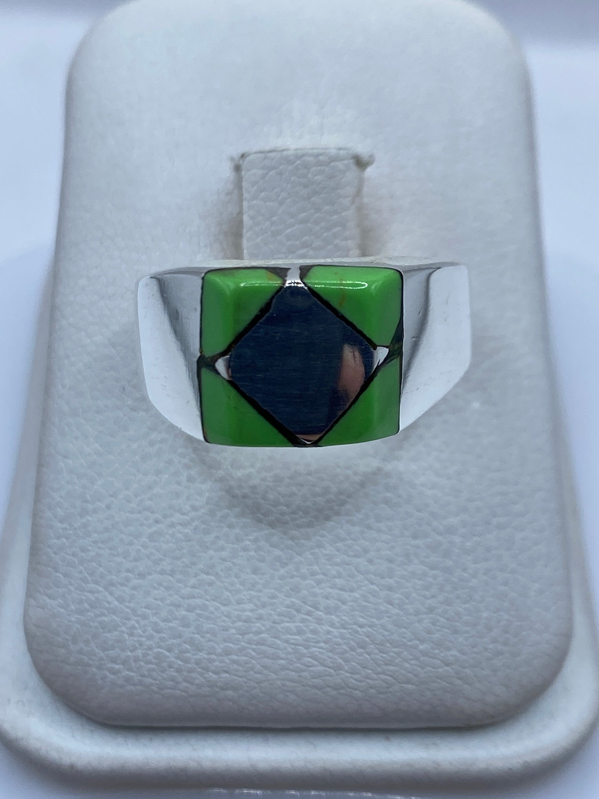 Anillo de plata .925 con piedra verde engastada, vista frontal sobre estuche blanco