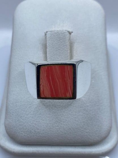 Anillo de plata .925 con coral rojo intenso engastado, vista frontal en estuche blanco